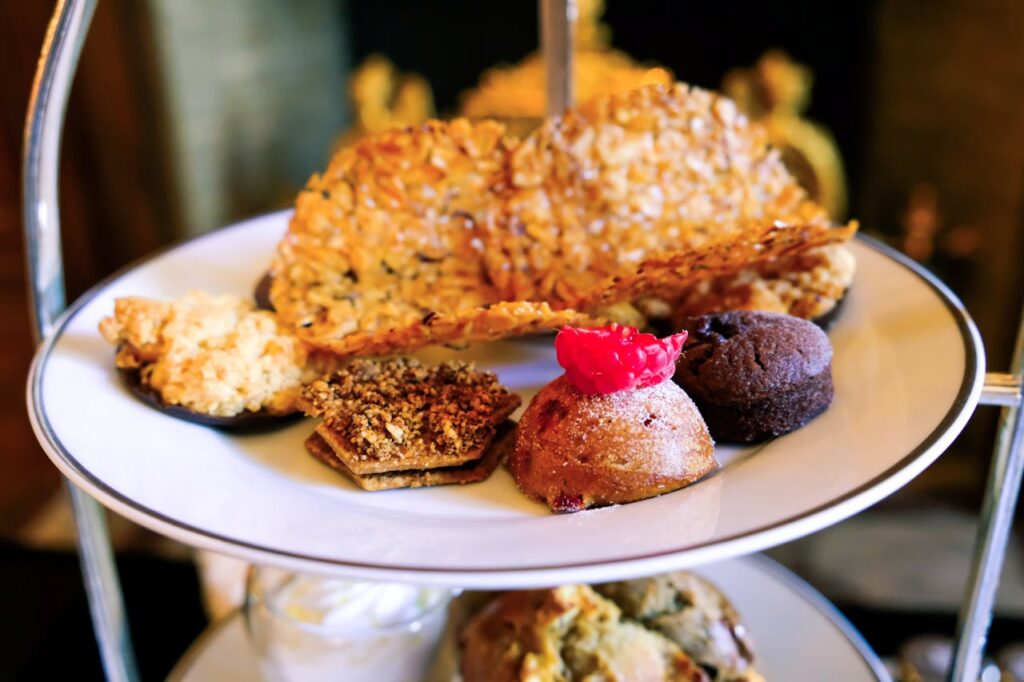 A delectable assortment of baked treats elegantly presented on a tiered dessert plate.